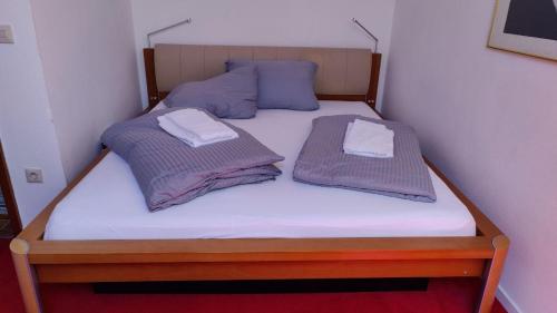 a bed with two pillows on top of it at Abendsonne in Saulgrub