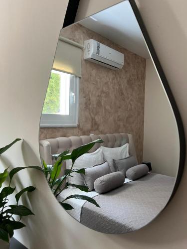 a mirror reflection of a bed in a room at Amare suite in Perivólia