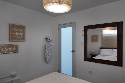 a bedroom with a mirror on the wall and a bed at VSS La Puntilla in Arecibo - Stylish Coastal Getaway in Arecibo