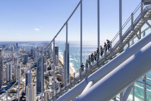people walking on a viewing platform at the top of the observation deck of the city at Whispering Pines - Stylish 3BR Duplex close to M1 in Pimpama