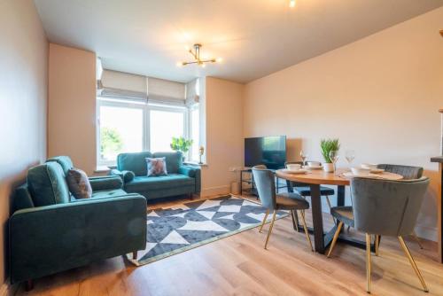 a living room with a table and chairs and a couch at Cartercroft, Sheffield in Sheffield