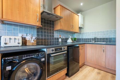 a kitchen with a washer and a dishwasher at Cartercroft, Sheffield in Sheffield