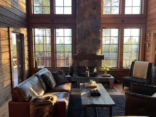 a living room with a leather couch and a table at "Rockyhill" Affordable beautiful luxury Lodge Idre sauna in Idre