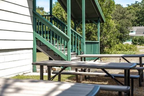 a group of picnic tables in front of a staircase at LumberJill Lodge Room 9 in Balsam Lake