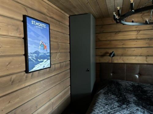 a room with a sign on a wall with a bed at "Rockyhill" Affordable beautiful luxury Lodge Idre sauna in Idre