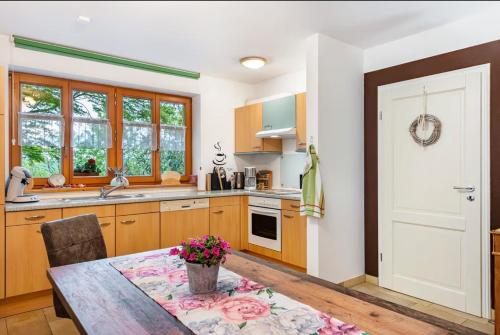 Una cocina con armarios de madera y una mesa. en Ferienwohnung am Fuchsbühl, en Schopfheim