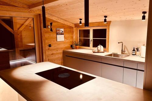 a kitchen with a sink and a counter top at Luxury family Chalet with extraordinary Mountain views in Trin