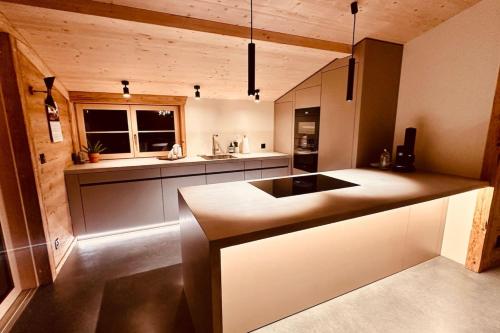 a kitchen with a sink and a counter top at Luxury family Chalet with extraordinary Mountain views in Trin