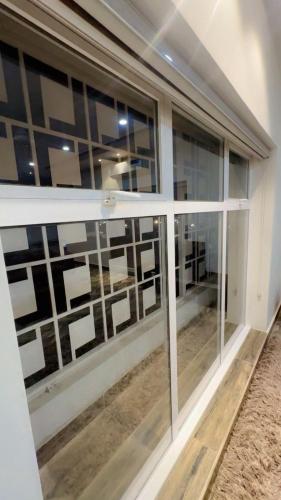 a room with a window with photographs on the wall at BBS Luxury Appartment in Multan
