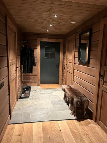 a room with a hallway with a door and a room with a dog at "Rockyhill" Affordable beautiful luxury Lodge Idre sauna in Idre