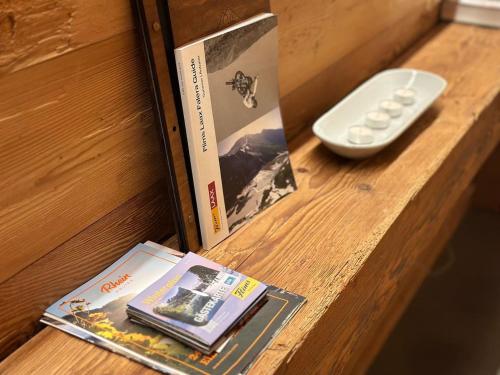 a book and a remote control on a table at Luxury family Chalet with extraordinary Mountain views in Trin