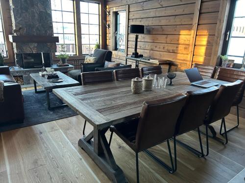 a living room with a wooden table and a laptop at "Rockyhill" Affordable beautiful luxury Lodge Idre sauna in Idre