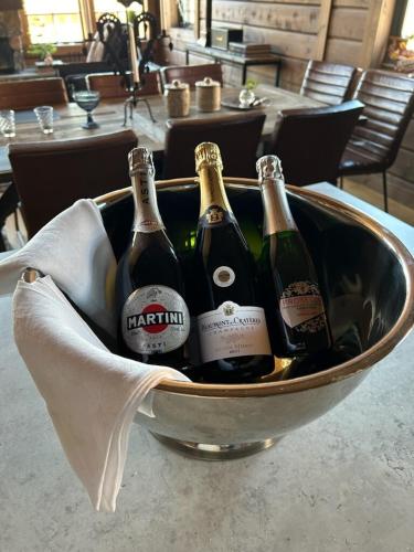 a metal bucket filled with bottles of champagne at "Rockyhill" Affordable beautiful luxury Lodge Idre sauna in Idre