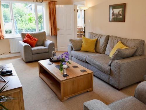 a living room with a couch and a coffee table at Millside in Morpeth