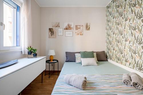 a bedroom with a bed and a window at DaDa Luxury Home in Bari