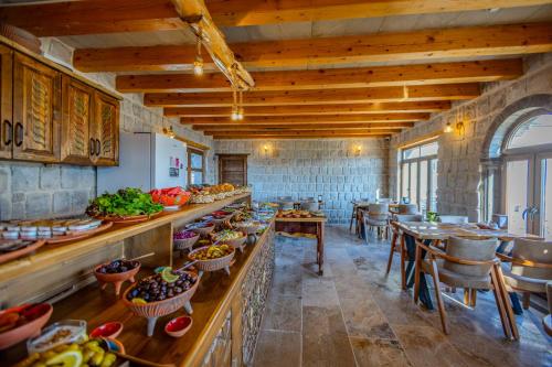 a large kitchen with tables and chairs in a restaurant at Gala Cave Cappadocia in Goreme