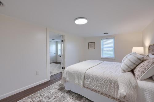 a white bedroom with a bed and a mirror at Homestead Haven in Gettysburg