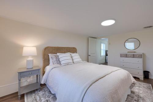 a white bedroom with a white bed and a night stand at Homestead Haven in Gettysburg