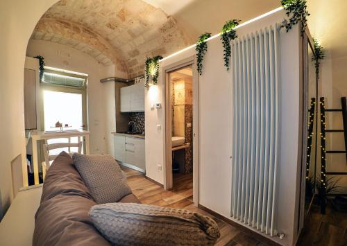 a living room with a couch and a kitchen at Suite Grotta della luna - Romantic Luxury Jacuzzi in Ostuni