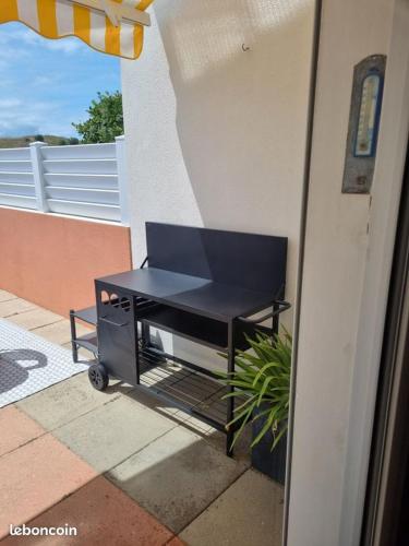 une table noire posée sur le côté d'un bâtiment dans l'établissement Maison bord de plage, à Saint-Hilaire-de-Riez