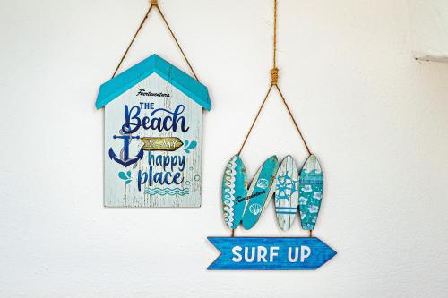 a sign for the beach happy place with three surfboards at Welooveyou Casa Ocean View in Costa Calma