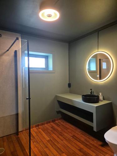 a bathroom with a sink and a mirror at Granli-Apartment in Stryn