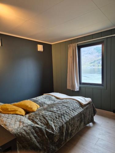 a bedroom with a bed and a window at Granli-Apartment in Stryn