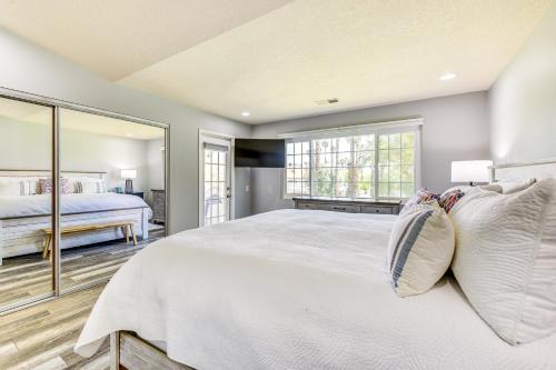 a bedroom with a large bed and a large mirror at Pool Access Newly Renovated Palm Desert Condo in Palm Desert