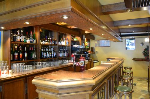 a bar with a lot of bottles of alcohol at Aiguille Noire in Valloire