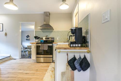 a kitchen with a stove and a counter top at Walk to Town and River Charming Home in North East! in North East