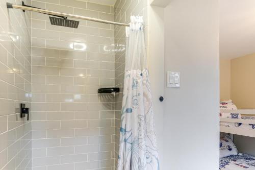 a shower with a shower curtain in a bathroom at Walk to Town and River Charming Home in North East! in North East