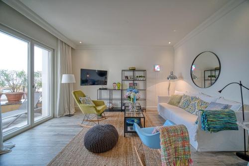 a living room with a white couch and a mirror at Lustica Bay Marina Village by 2BHome in Lustica