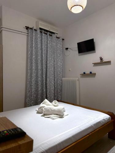 a bedroom with a bed with a towel on it at Rozy Studios in Pefki