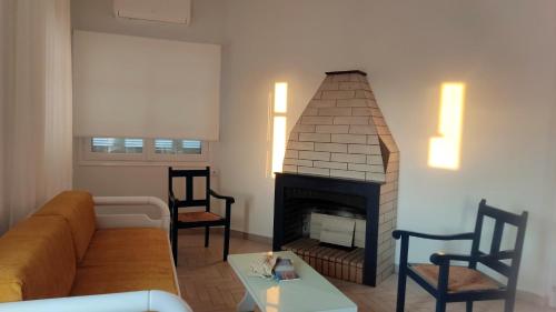 a living room with a couch and a fireplace at Tarmaros - Families & Groups in Sissi