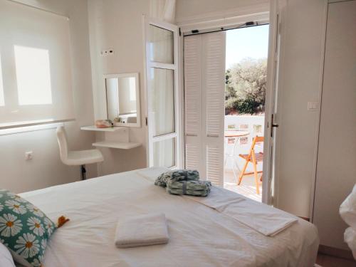 a bedroom with a bed and a door to a patio at Tarmaros - Families & Groups in Sissi