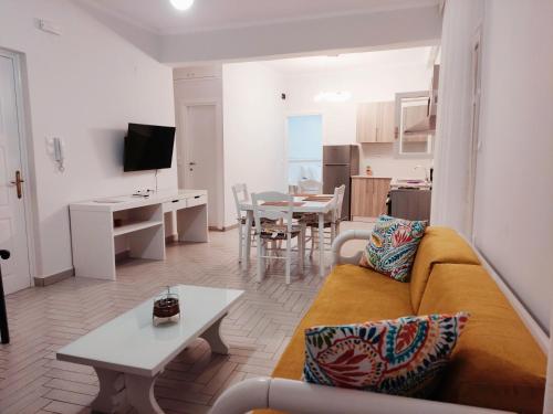 a living room with a couch and a table at Tarmaros - Families & Groups in Sissi
