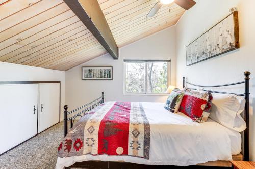 a bedroom with a large bed with a wooden ceiling at Private Hot Tub at Dog-Friendly Lake Arrowhead Gem in Lake Arrowhead