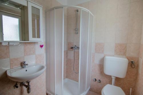 a bathroom with a shower and a toilet and a sink at Holiday Home Mia in Labin