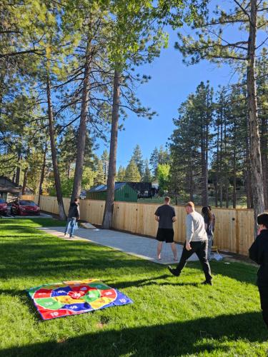 a group of people playing with a kite in the grass at Big Bear Frontier in Big Bear Lake