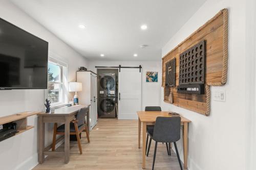 a kitchen with a table and a dining room at GameWall! Built in Bunks! Pet&Kid Friendly! Just Steps to the Sand! in Wareham