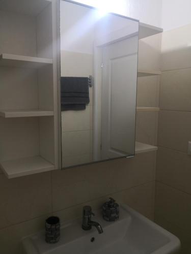 a bathroom with a sink and a mirror at Anastasia in Leptokarya