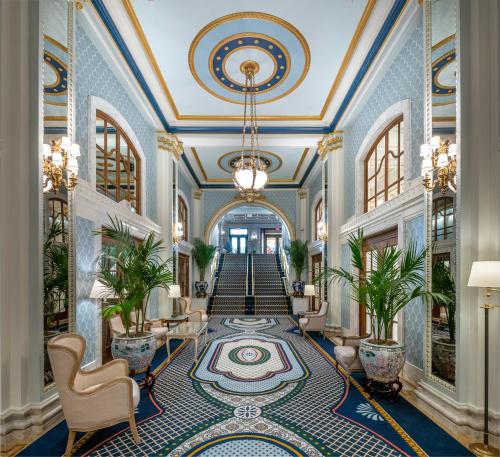 a lobby with a staircase with a blue and gold ceiling at Willard InterContinental Washington by IHG in Washington