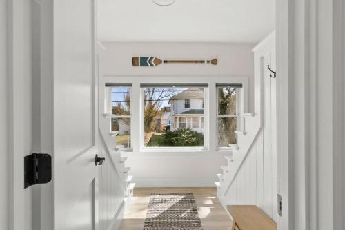 a hallway with a white door and a window at GameWall! Built in Bunks! Pet&Kid Friendly! Just Steps to the Sand! in Wareham