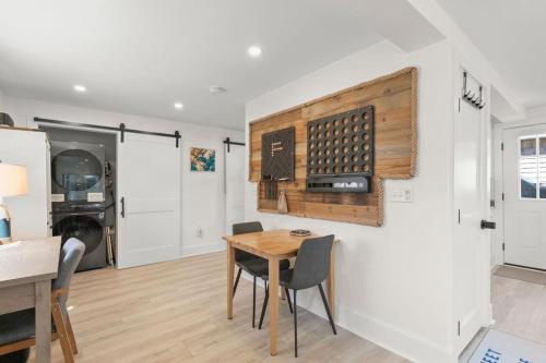 a kitchen and dining room with a table and chairs at GameWall! Built in Bunks! Pet&Kid Friendly! Just Steps to the Sand! in Wareham