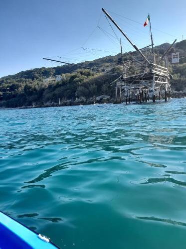 a boat in the water next to a dock at Le Mignole in Orsogna