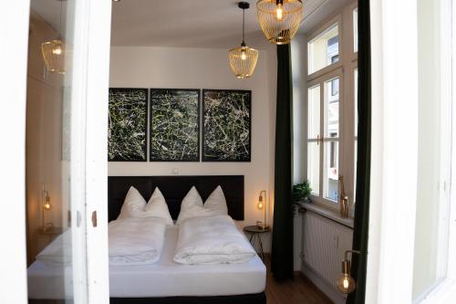 a bedroom with a bed with white pillows at Gemütliches Apartment im Zentrum Andernach in Andernach