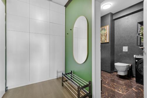 a bathroom with a toilet and a mirror at LAM Art Deco Castle View - AC - Balcony in Bratislava