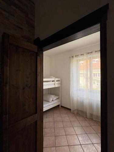 an open door to a room with a bedroom at Casa Chiara in Mandello del Lario
