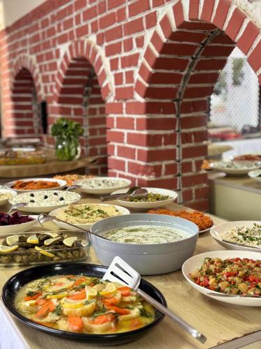 a buffet with many plates of food on a table at MOY Beldibi Hotel in Antalya