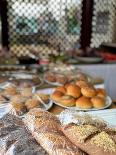 a table topped with plates of bread and pastries at MOY Beldibi Hotel in Antalya